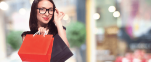 A woman buys new glasses while she is out shopping