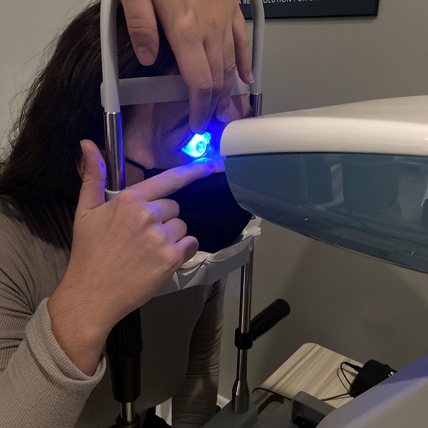 An optometrist uses scleral mapping technology during an eye exam.