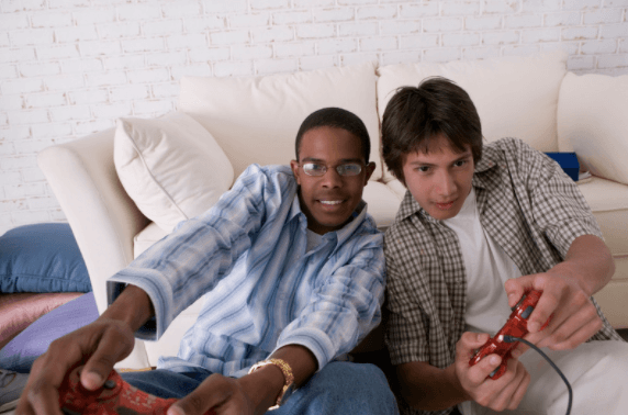 Two teenage boys play video games