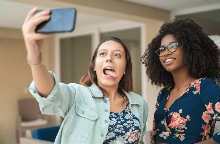 Two teen girls pose for a selfie in new glasses